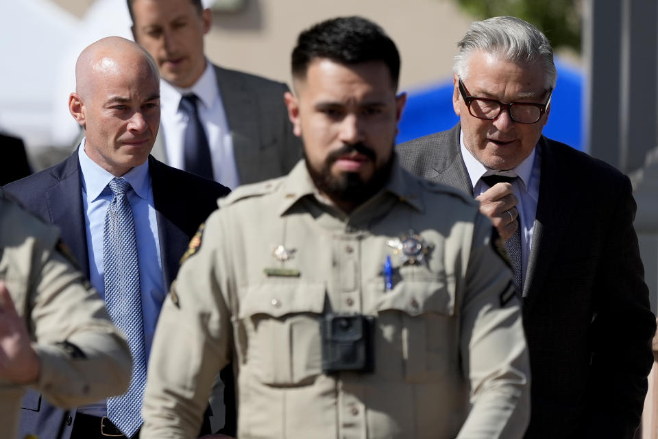 Actor Alec Baldwin, right, and attorney Luke Nikas, are escorted by deputies as they leave court after jury selection in Baldwin's involuntary manslaughter trial, Tuesday, July 9, 2024, in Santa Fe, N.M. (AP Photo/Ross D. Franklin)