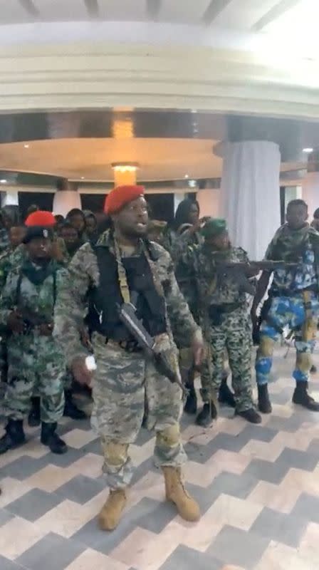 FILE PHOTO: A man in military fatigues speaks inside the Palace of the Nation during an attempted coup in Kinshasa