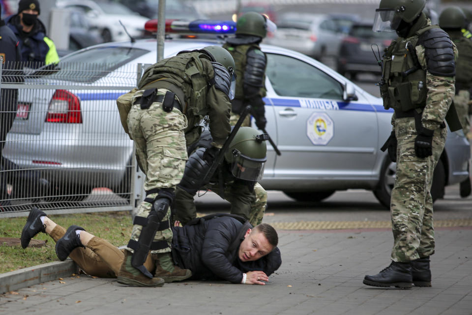 Police detain a demonstrator during an opposition rally to protest the official presidential election results in Minsk, Belarus, Sunday, Nov. 1, 2020. Some thousands of protesters swarmed the streets of the Belarus' capital on Sunday, demanding the resignation of the country's longtime authoritarian leader, and were met with police firing warning shots into the air and using stun grenades to break up the crowds. (AP Photo)