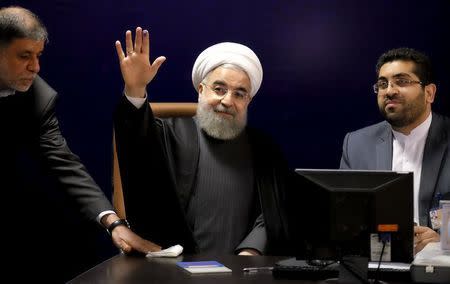 Iranian President Hassan Rouhani (C) waves after he registered for February's election of the Assembly of Experts, the clerical body that chooses the supreme leader, at the Interior Ministry in Tehran December 21, 2015. REUTERS/Raheb Homavandi/TIMA
