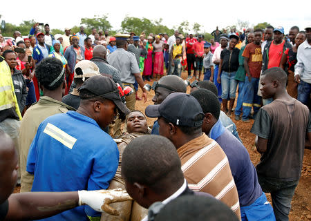 A rescued artisinal miner is carried from a pit as retrieval efforts proceed for trapped illegal gold miners in Kadoma, Zimbabwe, February 16, 2019. REUTERS/Philimon Bulawayo