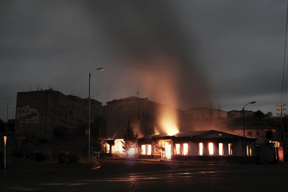 A building of a residential area burns after night shelling by Azerbaijan's artillery during a military conflict in self-proclaimed Republic of Nagorno-Karabakh, Stepanakert, Azerbaijan, early Sunday, Oct. 4, 2020. Armenian officials on Sunday accused Azerbaijan of carrying out strikes on Stepanakert. Azerbaijan's Defense Ministry said Armenian forces were attacking the towns of Terter and Horadiz from Stepanakert. (Areg Balayan/ArmGov PAN Photo via AP)