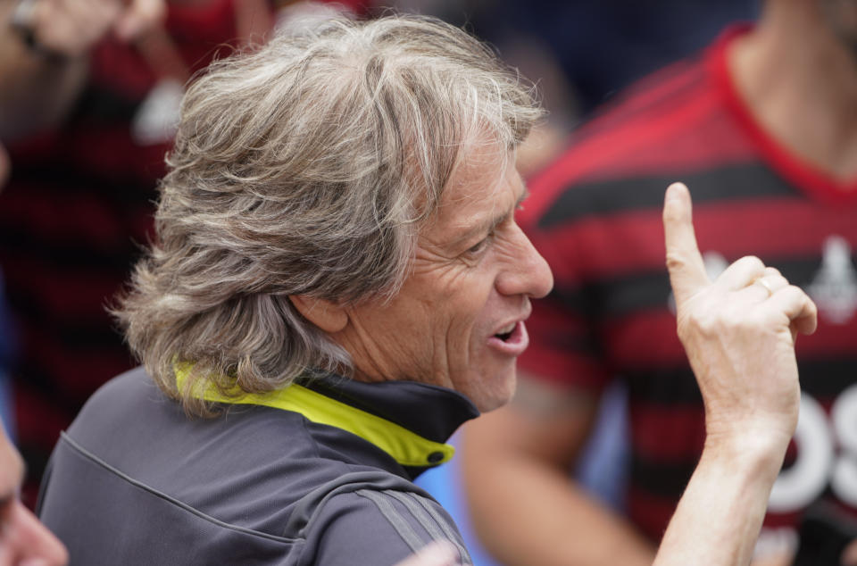 Jorge Jesus, coach of Brazil's Flamengo parades with the team at their arrival in Rio de Janeiro, Brazil, Sunday, Nov. 24, 2019. Flamengo overcame Argentina's River Plate 2-1 in the Copa Libertadores final match on Saturday in Lima to win its second South American title. (AP Photo/Ricardo Borges)