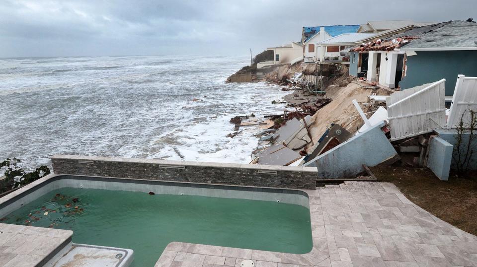 A small swimming pool teeters on the edge of collapse along South Atlantic Avenue in Wilbur-by-the-Sea. Some homes along the shoreline collapsed into the Atlantic Ocean on Thursday after being pounded by the rain, wind and surf generated by Tropical Storm Nicole. Seven homes were washed into the ocean, according to Volusia County Sheriff Mike Chitwood.