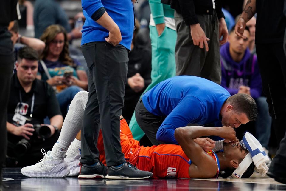 Thunder guard Shai Gilgeous-Alexander receives attention during the second half of Friday's NBA play-in tournament game after getting elbowed in the face by Timberwolves center Rudy Gobert.