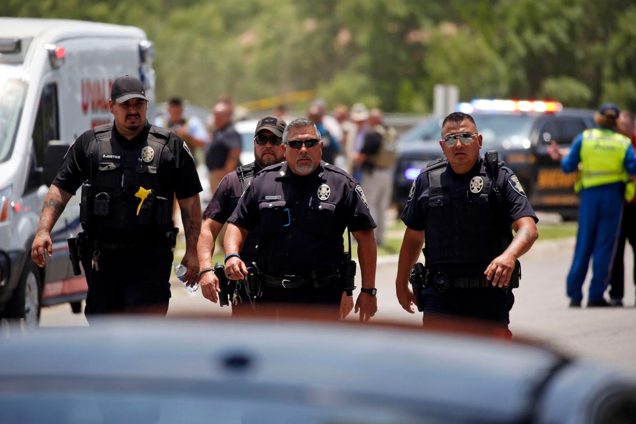 Police walk near Robb Elementary School following a shooting, Tuesday, May 24, 2022, in Uvalde, Texas. 