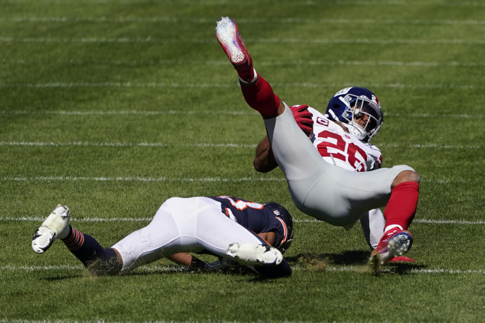 New York Giants running back Saquon Barkley (26) is brought down by Chicago Bears cornerback Kyle Fuller (23) during the first half of an NFL football game in Chicago, Sunday, Sept. 20, 2020. (AP Photo/Charles Rex Arbogast)