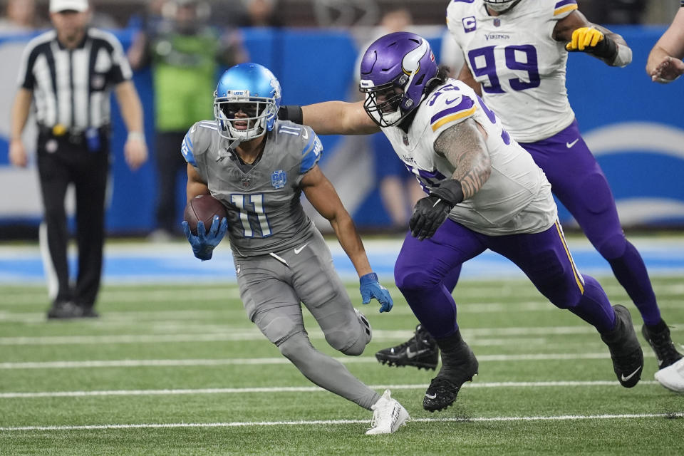 Detroit Lions wide receiver Kalif Raymond is chased by Minnesota Vikings defensive tackle Khyiris Tonga during the second half of an NFL football game, Sunday, Jan. 7, 2024, in Detroit. (AP Photo/Paul Sancya)