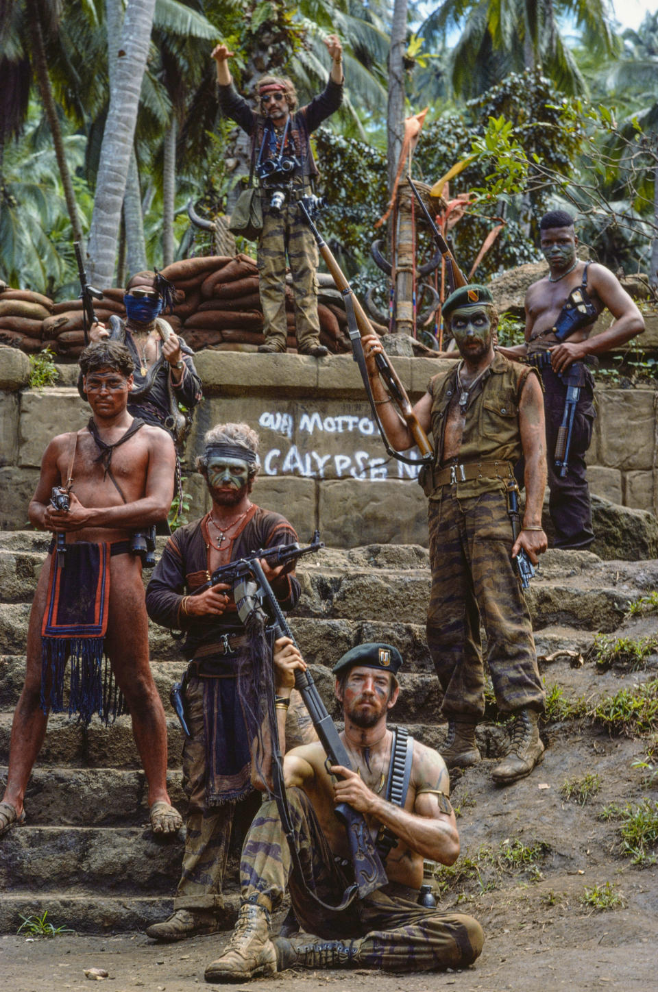 This image provided by Zoetrope Corp. shows Kurtz's army on the steps of his jungle compound in a scene from "Apocalypse Now Final Cut," directed by Francis Ford Coppola. The movie releases in theaters on Aug. 15, 2019. (Chas Gerretsen/Nederlands Fotomuseum/Zoetrope Corp. via AP)