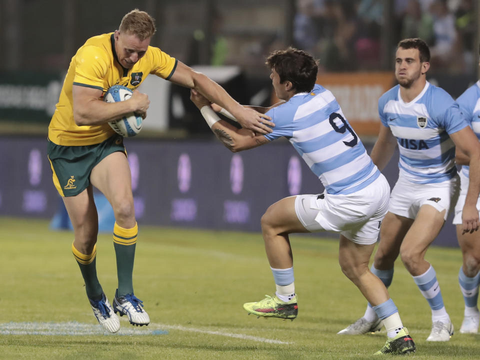 Australia's Reece Hodge, left, and Argentina's Gonzalo Bertranou scuffle for the ball during their Rugby Championship match in Salta, Argentina, Saturday, Oct. 6, 2018. (AP Photo/Gonzalo Prados)