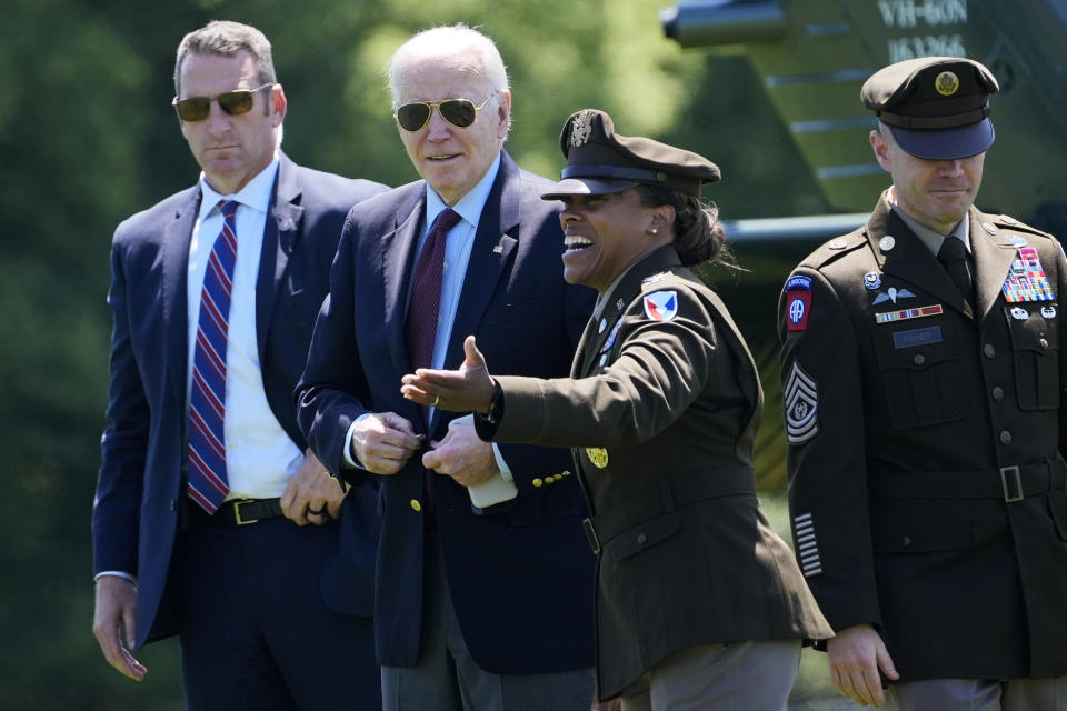 President Joe Biden, from second left, is greeted by Col. Tasha Lowrey, Joint Base Myer–Henderson Hall commander, and Command Sergeant Maj. Michael Fisheras, as he walks off of Marine One at Fort Lesley J. McNair in Washington, as he returns from a weekend in Delaware, Monday, May 13, 2024. (AP Photo/Susan Walsh)