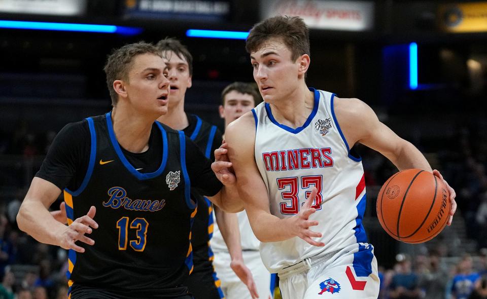 Linton-Stockton Miner Joey Hart (33) drives the ball past Fort Wayne Blackhawk Christian Brave Josh Furst (13) during IHSAA Class 2A state finals Saturday, March 25, 2023, at Gainbridge Fieldhouse in Indianapolis. Fort Wayne defeated Linton-Stockton for the title, 52-45.