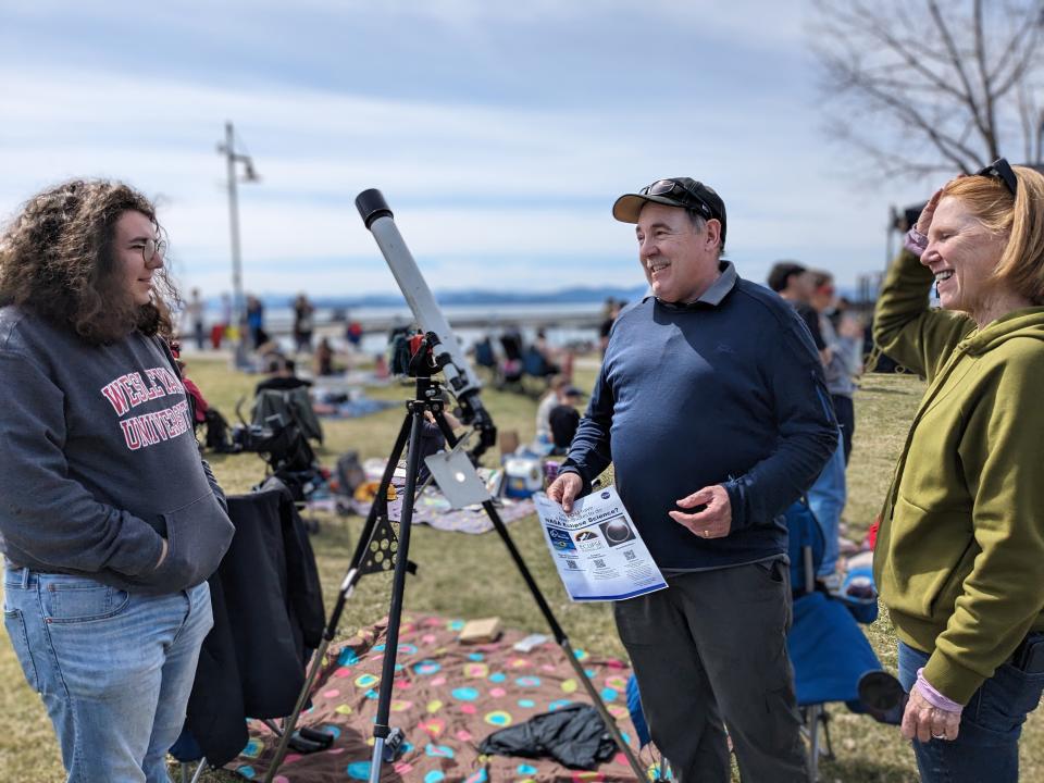 On Monday, April 8, Hampton, New Hampshire residents Chris (center) and Beth (right) Finnell talk to a Wesleyan University student about their Montgomery Ward telescope, which Chris has owned since 7th grade in 1975.