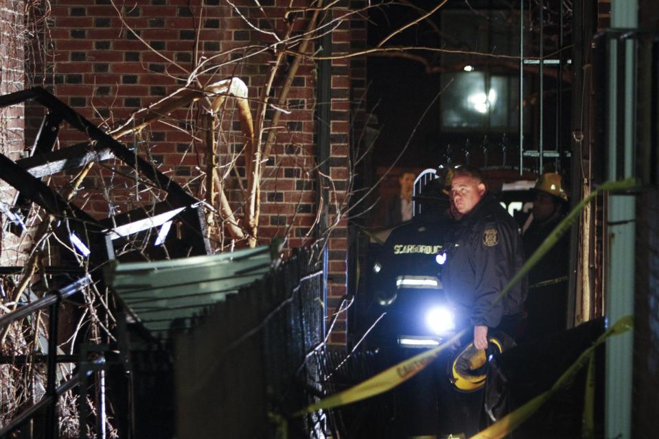 Firefighters look at a fourth-floor balcony Sunday, Jan. 12, 2014 that collapsed at the historic John C. Bell building around midnight Saturday in the Rittenhouse Square section of Philadelphia, killing a young man and injuring two women, police said. Police say a 22-year-old man who suffered severe head and neck injuries in the fall was pronounced dead at a hospital early Sunday morning. The two women are in their 20s and suffered broken bones in their backs. They are listed in stable condition at two city hospitals. The man and two women, who were attending a birthday party, had stepped out onto the balcony to smoke cigarettes when the collapse occurred, authorities said. (AP Photo/ Joseph Kaczmarek)