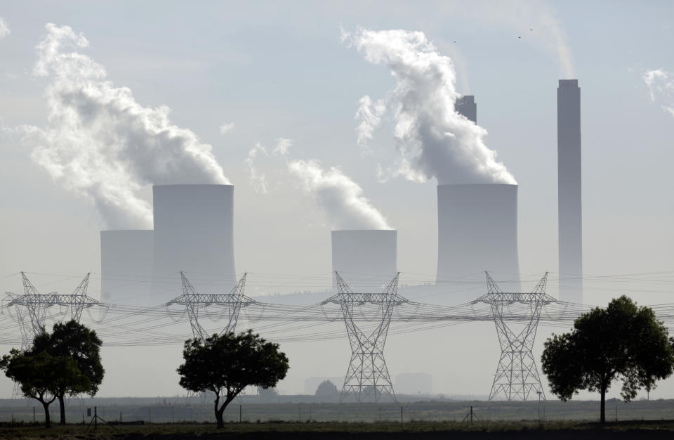 FILE - In this Wednesday, Dec. 5, 2018 file photo smoke billows from the chimneys at Lethabo Power Station, a coal fired power station, in Vereeniging, South Africa. (AP Photo/Themba Hadebe, File)