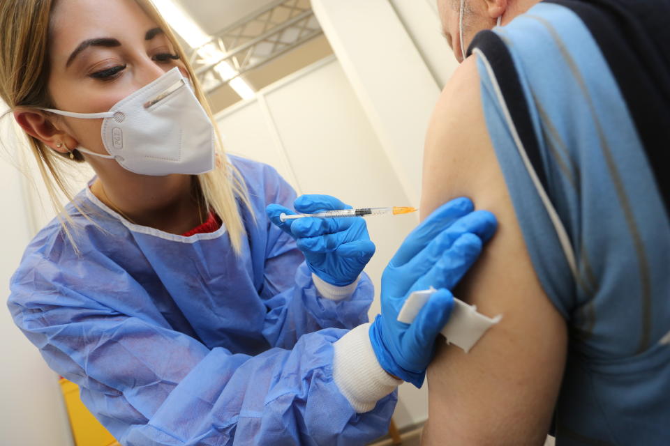 Geriatric nurse Jasmin Lasse vaccinates in the vaccination centre in Quedlinburg, Germany, Thursday, May 13, 2021. Germany's coronavirus infection rate dropped to its lowest level in nearly two months on Friday, while the health minister said the country had the most successful day yet of its vaccination campaign this week. (Matthias Bein/dpa via AP)