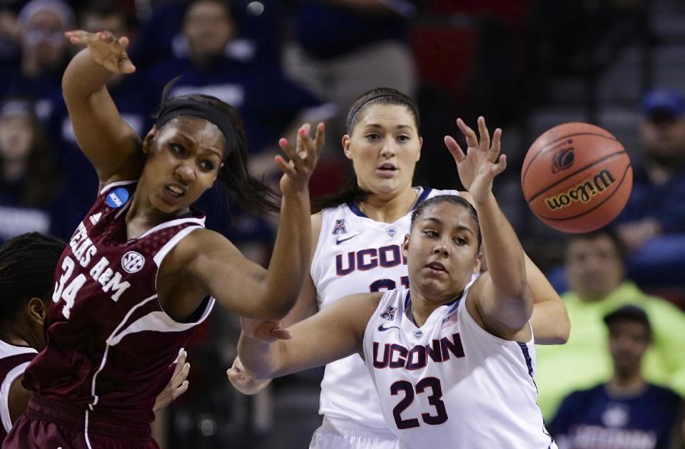 Texas A&M's Karla Gilbert (34), Connecticut's Kaleena Mosqueda-Lewis (23) and Connecticut's Stefanie Dolson, center rear, go for a rebound during the first half of a regional final game in the NCAA college basketball tournament in Lincoln, Neb., Monday, March 31, 2014. (AP Photo/Nati Harnik)