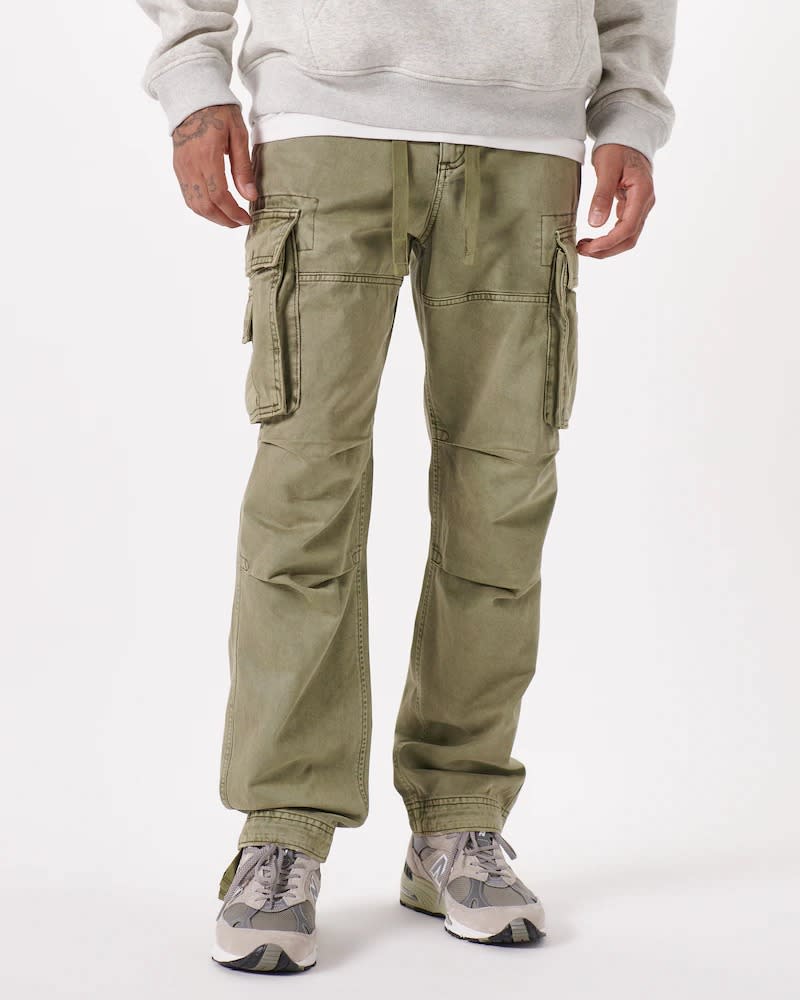 pale olive cargo pants worn with sneakers