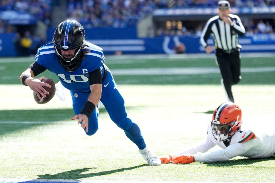 Indianapolis Colts quarterback Gardner Minshew (10) runs away from Cleveland Browns safety Juan Thornhill, right, for a 4-yard touchdown on Oct. 22, 2023, in Indianapolis.