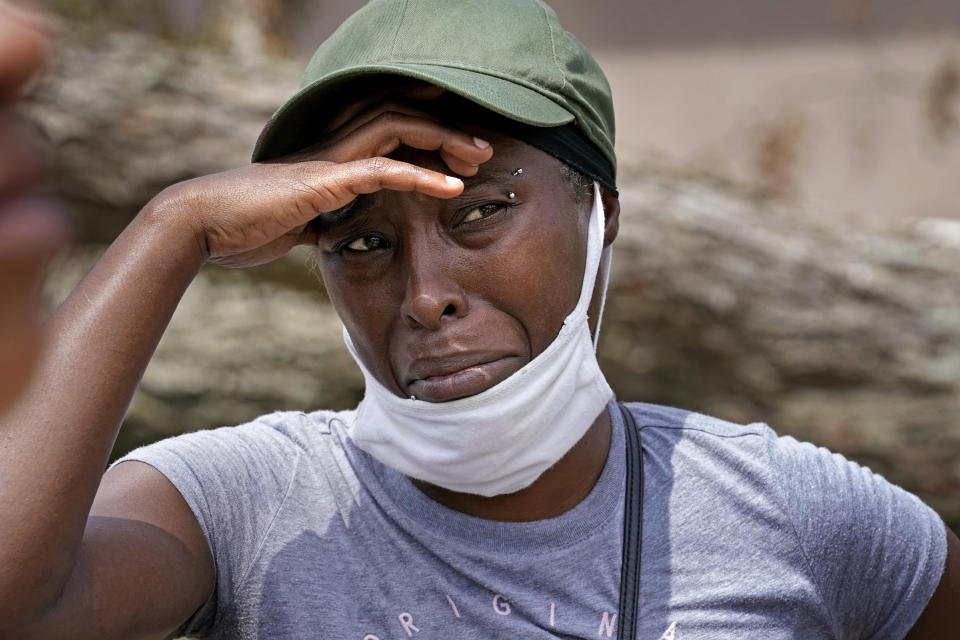 Linda Smoot, who evacuated from Hurricane Laura in a pickup truck with eight others, reacts as they return to see their homes, in Lake Charles, La., in the aftermath of the hurricane, Sunday, Aug. 30, 2020. (AP Photo/Gerald Herbert)