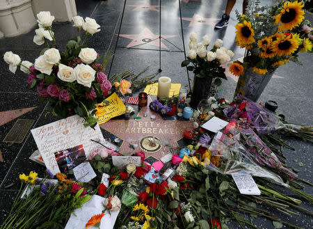 The star of Tom Petty and the Heartbreakers is adorned with flowers and other items on the Hollywood Walk of Fame in Los Angeles, California, U.S., October 3, 2017. Petty died at 66. REUTERS/Mario Anzuoni