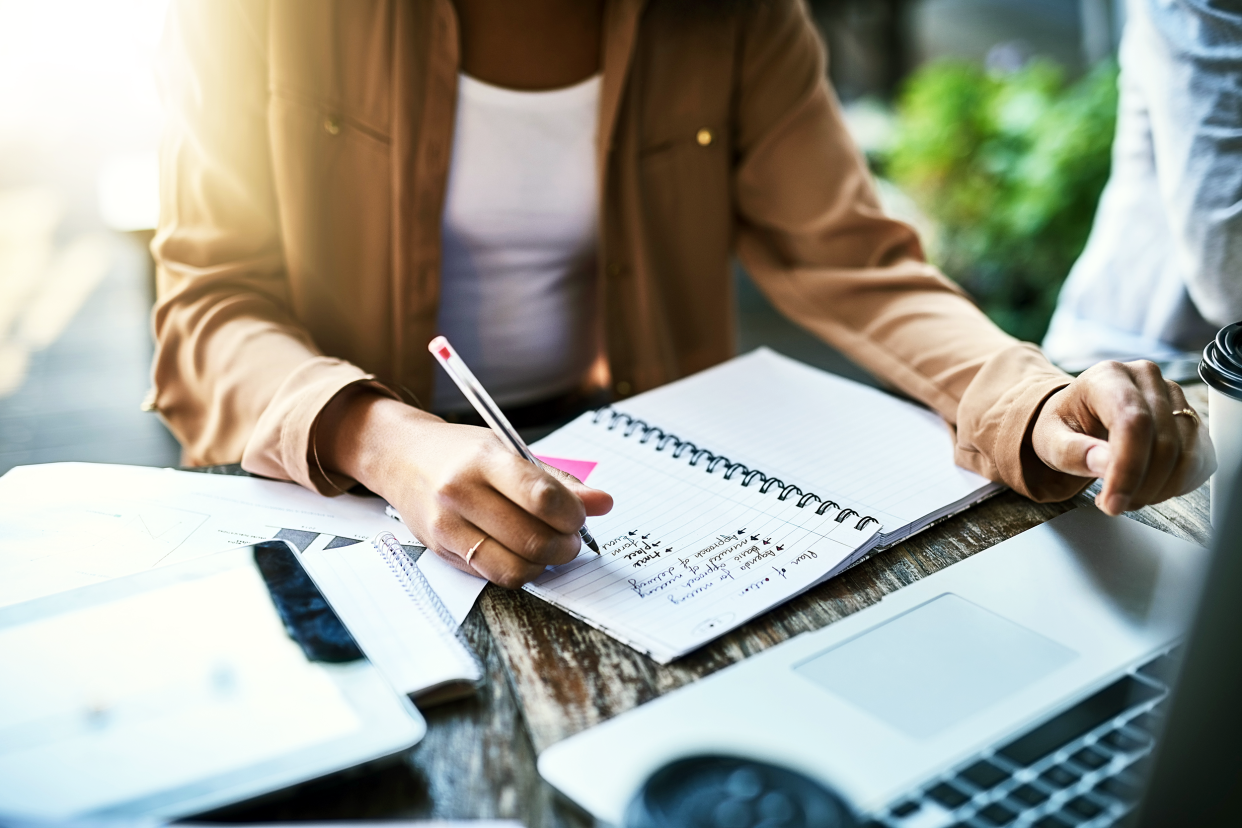 Woman writing down plans in a notebook