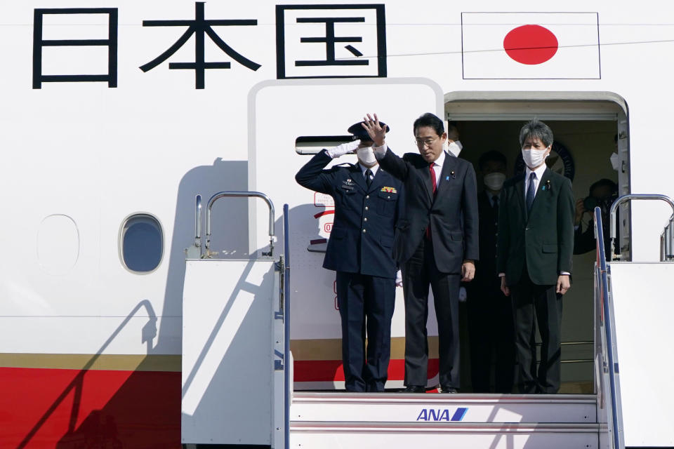 Japanese Prime Minister Fumio Kishida, center, waves as his departure for Australia, at Haneda international airport in Tokyo, Friday, Oct. 21, 2022. Kishida, heading to Australia for talks with his Australian counterpart, Anthony Albanese, said Friday that he wants to bolster military and energy cooperation between the two countries that are increasingly getting closer over shared concern about China's rise.(Kyodo News via AP)