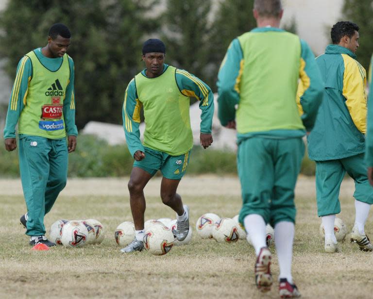 South African football team captain John "Shoes" Moshoeu (2L) trains with teammates in 2004 in the Tunisian town of Sousse