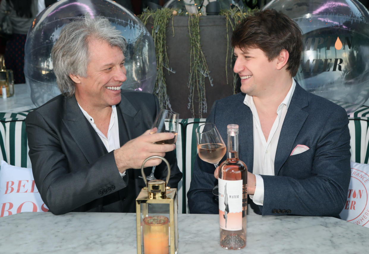 Jon Bon Jovi and son Jesse Bongiovi celebrate the L.A. launch of their Hampton Water wine. (Photo: Jerritt Clark/Getty Images for Hampton Water)