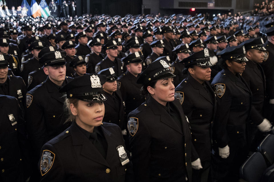 Newest NYPD graduates standing at attention