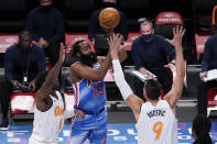 Brooklyn Nets guard James Harden, center, shoots past Orlando Magic forward Dwayne Bacon, left, and center Nikola Vucevic, right, during the first half of an NBA basketball game, Saturday, Jan. 16, 2021, in New York. (AP Photo/Mary Altaffer)