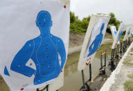 In this Monday, July 30, 2018 photo, silhouette targets used by Broward County Public Schools' newly-hired armed guardians are shown after firearms training at the Broward Sheriff's Office gun range in Markham Park in Sunrise, Fla. Twenty-two of the Florida school districts are supplementing officers with "guardians" -- armed civilians or staff. They are vetted, receive 132 hours of training and must attain a higher score on the state firearms test than rookie police officers. (AP Photo/Wilfredo Lee)