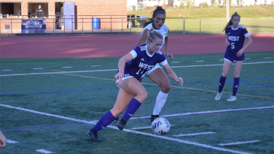 Reilly McGlinn (11) of Cherry Hill West controls the ball as Bianca Anghelache of Cherry Hill East applies pressure during their game at Jonas C. Morris Stadium on Saturday, September 24, 2022.