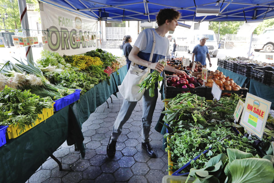 In this May 20, 2019 photo, Jonah Reider shops for vegetables in New York's Union Square Greenmarket. Reider became a national sensation when he was a Columbia University senior several years ago, booted from his dorm for running a sophisticated supper club there. (AP Photo/Richard Drew)