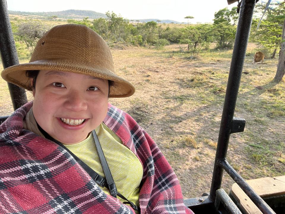 Author Fiona Chandra in front of a lion