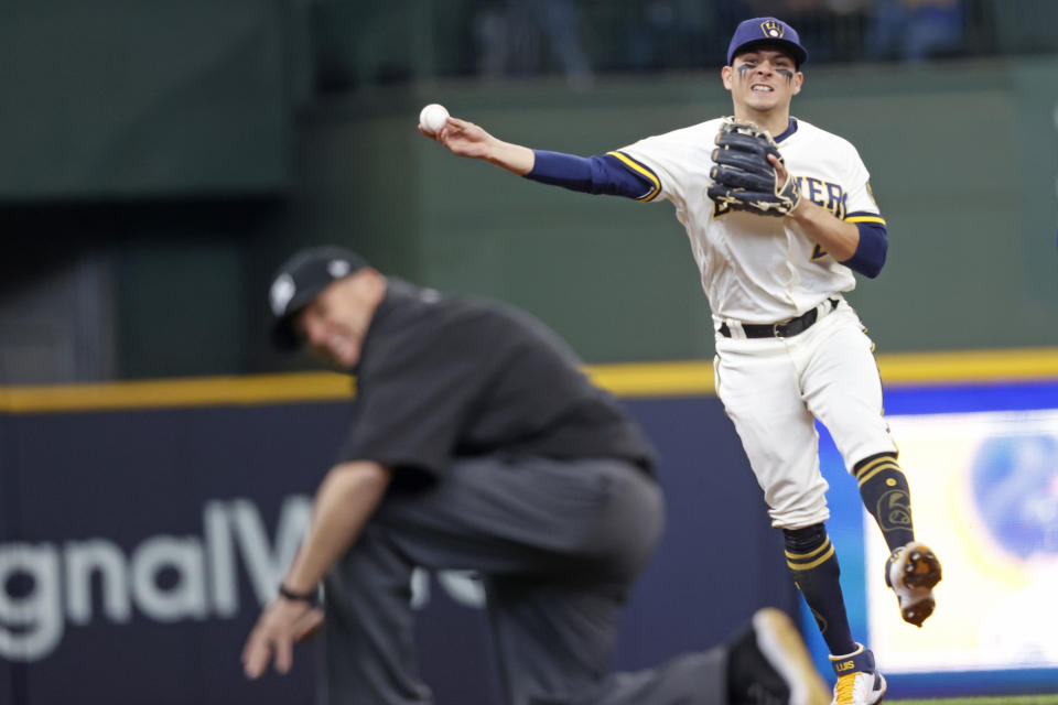 Milwaukee Brewers third baseman Luis Urias (2) throws out San Diego's San Diego Padres shortstop Jorge Mateo (3) during the fifth inning of a baseball game Thursday, May 27, 2021, in Milwaukee. (AP Photo/Jeffrey Phelps)