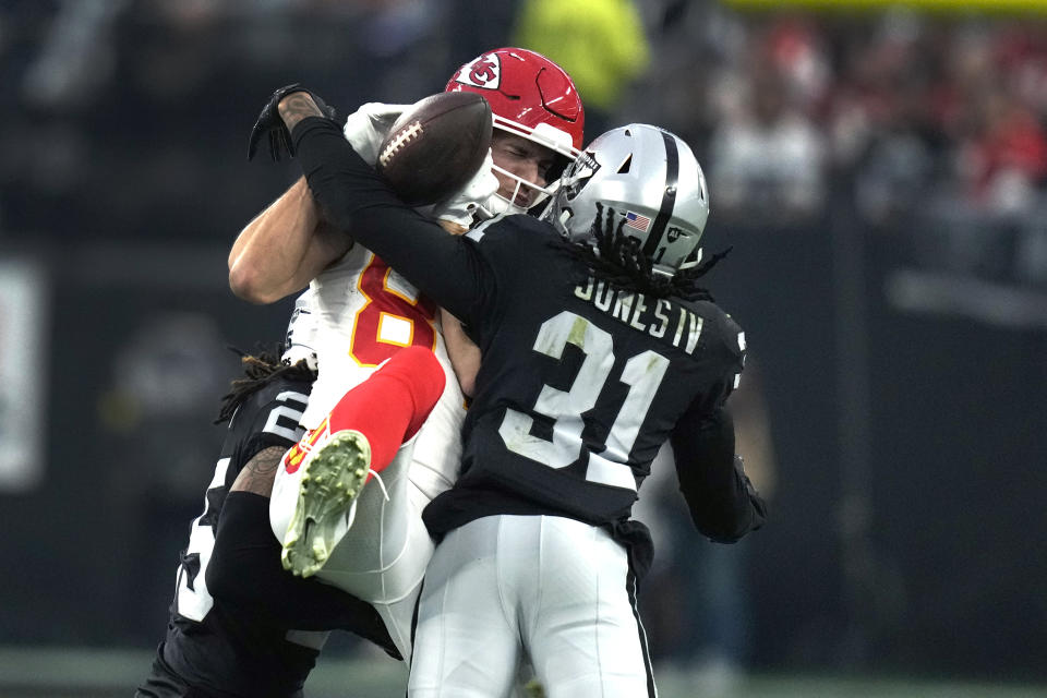 Kansas City Chiefs wide receiver Justin Watson, left, is unable to hold on to a pass as Las Vegas Raiders cornerback Sidney Jones IV (31) defends during the second half of an NFL football game Saturday, Jan. 7, 2023, in Las Vegas. (AP Photo/John Locher)