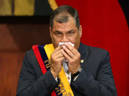 Ecuador's President Rafael Correa holds a handkerchief to his face during the inauguration of President-elect Lenin Moreno (not pictured) at the National Assembly in Quito, Ecuador May 24, 2017. REUTERS/Mariana Bazo