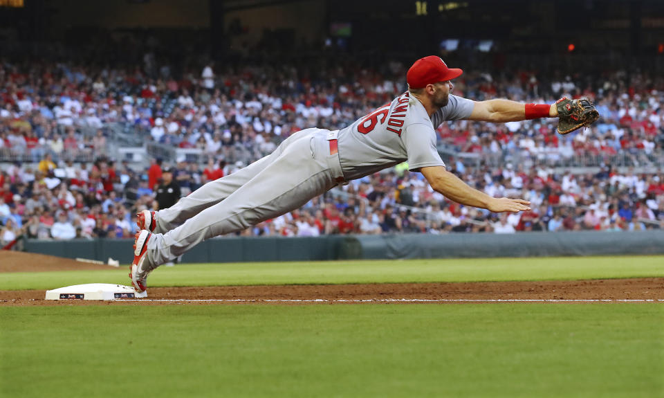 St. Louis Cardinals first baseman Paul Goldschmidt manages to just keep his foot on the bag for the out, taking the throw from third baseman Nolan Arenado on a grounder by Atlanta Braves' Matt Olson during the fourth inning of a baseball game Wednesday, July 6, 2022, in Atlanta. (Curtis Compton/Atlanta Journal-Constitution via AP)