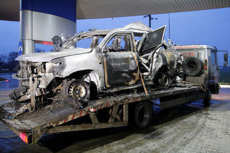 The damaged vehicle that drove over a mine while transporting members of the Organization for Security and Cooperation in Europe (OSCE), who were killed and injured from the incident on Sunday, is seen at a petrol station while it is moved from the scene in Luhansk region, Ukraine, April 23, 2017. REUTERS/Alexander Ermochenko