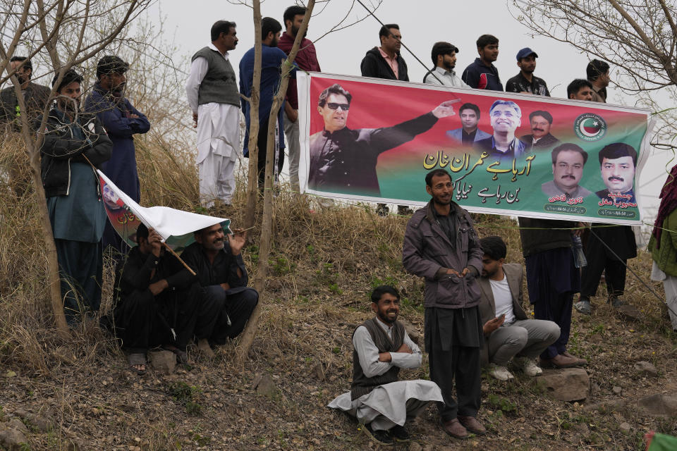 Supporters of former Pakistani Prime Minister Imran Khan wait for their leader outside a court, in Islamabad, Pakistan, Tuesday, Feb. 28, 2023. A Pakistani court approved bail for Khan after he appeared before a judge in Islamabad amid tight security, officials said, months after police filed terrorism charges against the country's popular opposition leader for inciting people to violence. (AP Photo/Anjum Naveed)