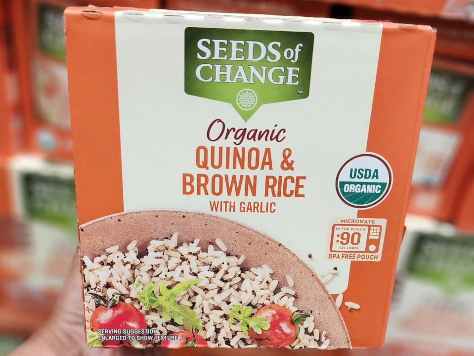 The writer holds a box of Seeds of Change quinoa and brown rice