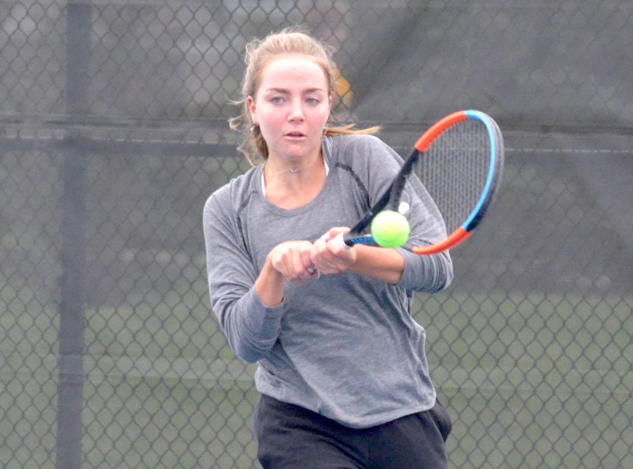 Holland Christian's Bria Lampen returns a shot against Hamilton.