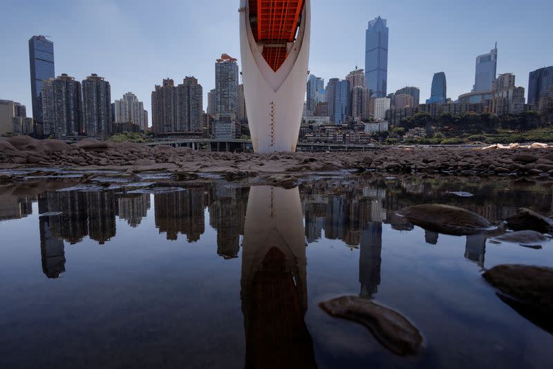 The central pillar of Qiansimen bridge stands exposed on the dried-up riverbed of the Jialing river that is approaching record-low water levels in Chongqing