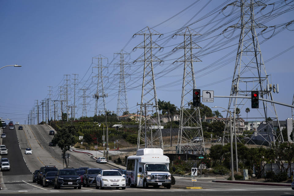 Power transmission towers line a street in Redondo Beach, Calif., Wednesday, Sept. 7, 2022. With record demand on power supplies across the West, California snapped its record energy use around 5 p.m. with 52,061 megawatts, far above the previous high of 50,270 megawatts set July 24, 2006. (AP Photo/Jae C. Hong)