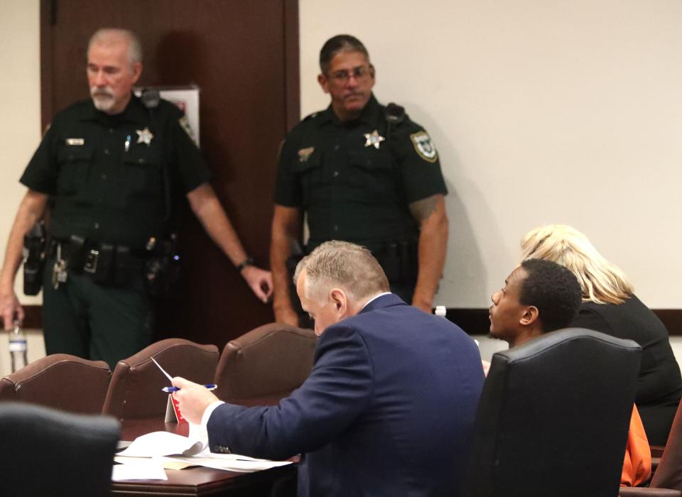 Defendant Charles Ivy sits with his defense team on Wednesday, Dec. 13, 2023. Ivy's lawyers asked for a gag order on police and prosecutors, but the judge rejected the request.