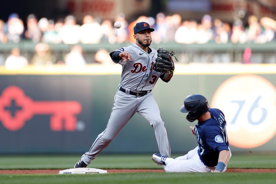 Tigers second baseman Harold Castro turns a double play over Mariners right fielder Mitch Haniger during the sixth inning of the first game of the doubleheader on Tuesday, Oct. 4, 2022, in Seattle.