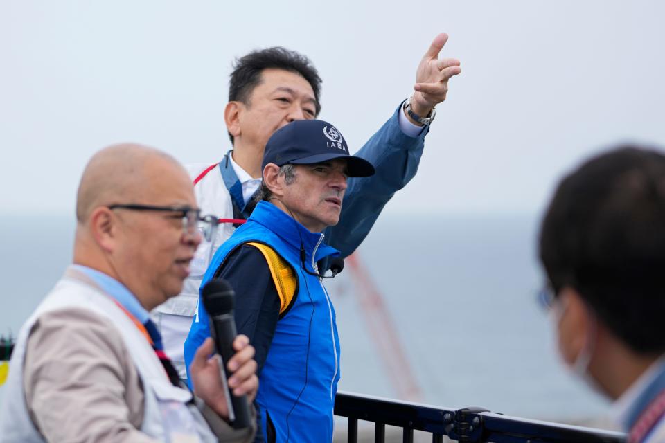 Rafael Mariano Grossi, Director General of the International Atomic Energy Agency, center, listens to Tomoaki Kobayakawa, President of Tokyo Electric Power Co., center back, explain facilities to be used to release treated wastewater, while visiting the damaged Fukushima nuclear power plant in Futaba, northeastern Japan, Wednesday, July 5, 2023.