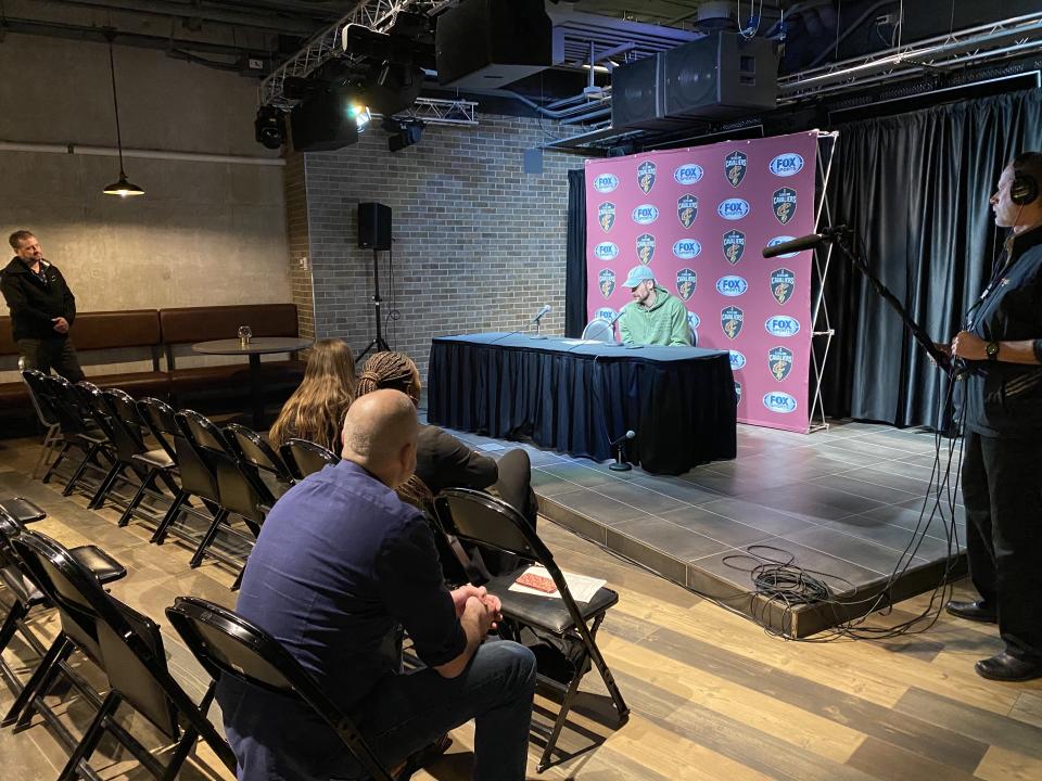 Kevin Love speaks to the media postgame at a podium rather than in the locker room. (Henry Bushnell/Yahoo Sports)