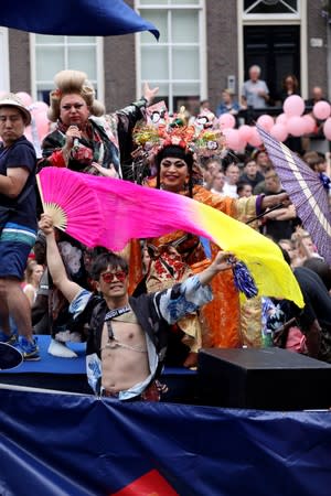 Participants cruise the canals in boats during the annual gay pride parade in Amsterdam